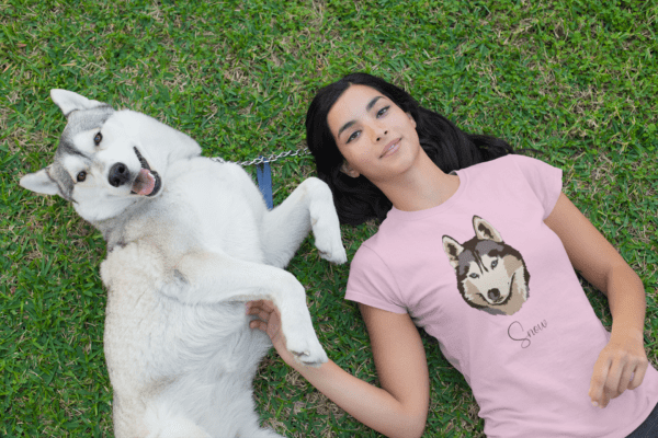 t shirt mockup of a woman lying on the grass with her dog 30660